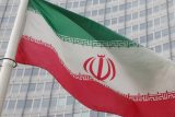 Íránská vlajka vlaje před sídlem Mezinárodní agentury pro atomovou energii (MAAE) ve Vídni, 6. března 2023