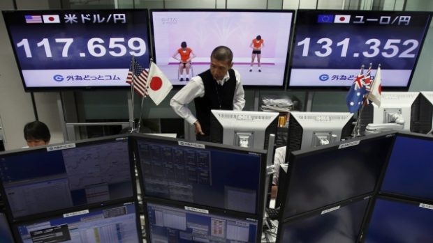 Tokio. Zaměstnanec burzovní společnosti před obrazovkami s kurzem