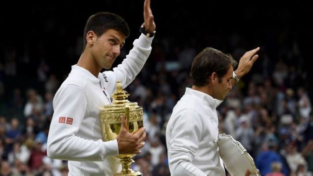 Djoković s titulem, Federer v pozadí, typický obrázek pro finále Wimbledonu v posledních letech