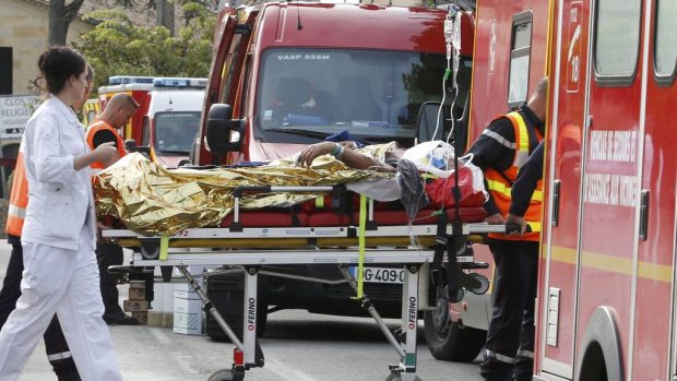 Záchranáři odvážejí zraněné při nehodě autobusu s nákladním autem v jihozápadní Francii