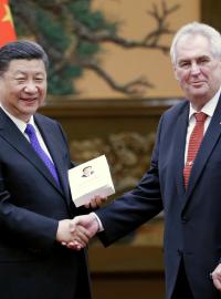Dárek pro hosta, který vážil dalekou cestu: čínský prezident Si předává Miloši Zemanovi svou autorskou knihu.